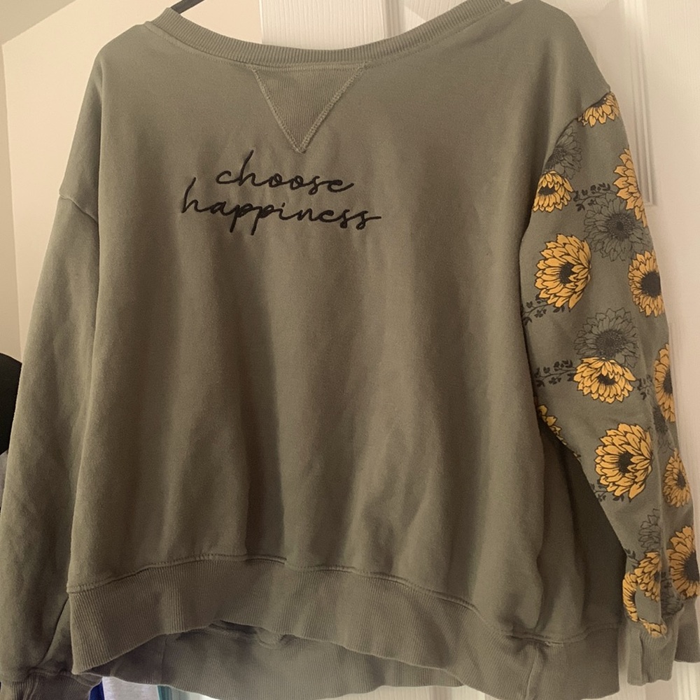 I am selling a green casual sweat shirt with yell flowers on the left arm.